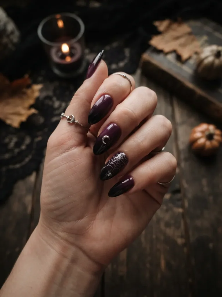 ![Moody Halloween ombre nails blending deep purple into glossy black, accented with a small silver crescent moon and spiderweb, vertical Pinterest photography.]